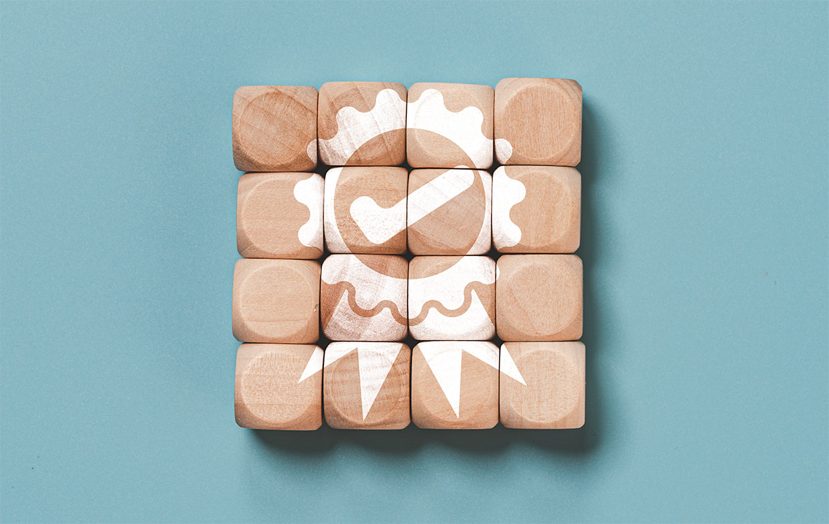 Quality assurance icon which print screen on wooden cube block for quality guarantee and ISO certificate of product and service concept.